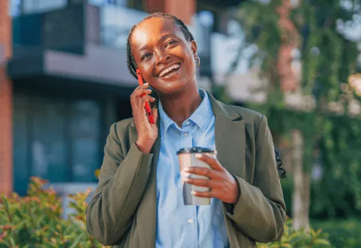 A woman in a business suit engaged in a phone conversation, exuding professionalism and focus.