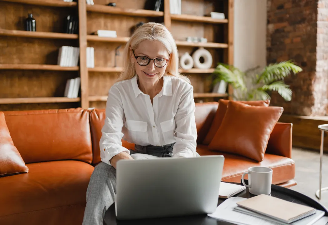 A woman is using her laptop while on a RingCentral video call